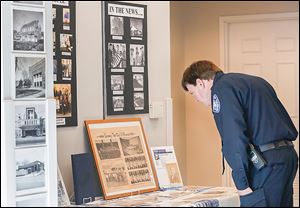 Maumee police Chief Jim MacDonald views historical memorabilia during the celebration of the 50th anniversary of Maumee Municipal Court.