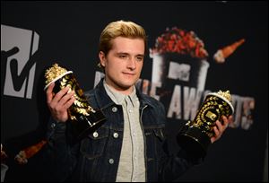 Josh Hutcherson poses with his best male performance award and movie of the year award for 