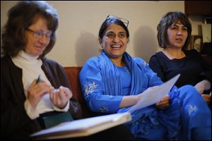 Valerie Garforth, left, Dr. Samina Hasan, center, and Nazife Amrou participate in a Toledo Compassionate community team meeting,