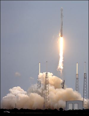 A rocket carrying the SpaceX Dragon ship lifts off from launch complex 40 today at the Cape Canaveral Air Force Station in Cape Canaveral, Fla.