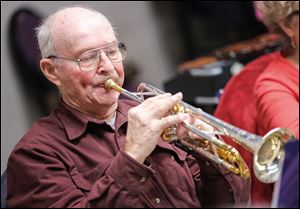 Korean War veteran Jim Meyers rehearses with the Owens Community College Band for the upcoming spring concert. A certificate of thanks is being prepared for World War II veterans.