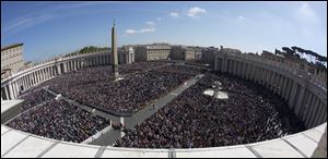 A large crowd is seen in St. Peter's Square from the Bernini colonnade towards Via della Conciliazione avenue, top, during Pope Francis' Easter Mass, at the the Vatican, today.
