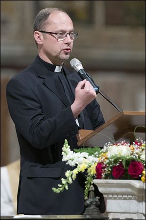 Msgr. Slawomir Oder, postulator of late Pope John Paul II, delivers his speech in Rome’s St. John Lateran Basilica on Tuesday. The meeting was organized to prepare for Sunday’s elevation to sainthood of Pope John Paul II and Pope John XXIII. 