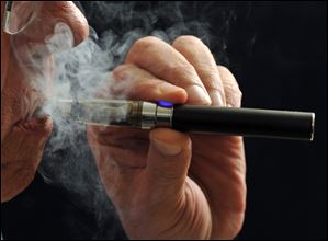 A smoker demonstrates an e-cigarette. 
