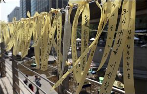 Yellow ribbons are displayed as a sign of hope for safe return of passengers of the sunken ferry boat Sewol in the of fence along the Cheonggye stream in Seoul, South Korea, today.