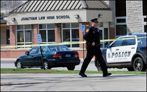 Police remain on scene at Jonathan Law High School after a 16-year-old girl was stabbed to death in Milford, Conn., today.