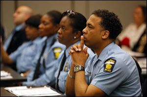 Donald Hatch, with the Toledo Police Departmen, listens while Sgt. John Nebl of the Schaumburg, Ill., police department , not pictured, speaks during a 