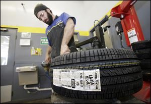 Lonn Schubert installs a Goodyear tire on a rim in South Euclid, Ohio, in February.