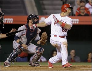 Los Angeles Angels' Raul Ibanez watches his RBI-triple in front of Cleveland Indians catcher Yan Gomes during the eighth inning.