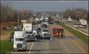 Traffic is diverted around a crash on northbound I-75 near the Erie, Mich. exit.