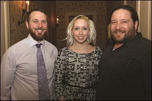 LeSo Art Gallery assistant director Bradley Scherzer, left, and co-owners Amber LeFever, center, and Adam Soboleski, attend the Passport to Hope event.