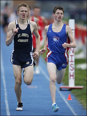 Nick Jarrell, left, of St. John's edges David St. John of St. Francis in the 1600 meter run during the Knight Relays.