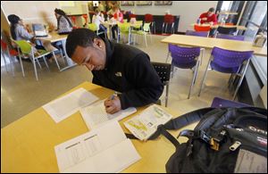 Johnny Reese, a senior at the University of Toledo, studies at the cafeteria in the student union on campus. Mr. Reese says he feels optimistic about the hunt for a job. And while there are reasons for optimism, experts caution that job-hunting is still tough.