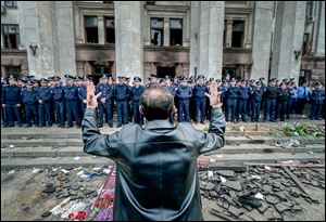 Police guard the burned trade union building in Odessa, Ukraine, on Saturday. More than 30 people died trying to escape during clashes the day before. 
