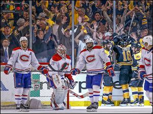 Montreal players react as Boston fans celebrate Reilly Smith’s goal to give the Bruins the lead in the third.