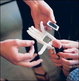 A Westtown High School engineering student shows off the hand.