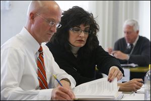 Daniel DeAngelis, left, Deputy Director of the Board of Elections, and Gina Kaczala, right, Director, during a Board of Elections meeting at One Government Center on April 15.