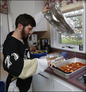 Ryan Johnston helps prepare pasta.