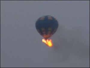 Virginia State Police received calls of the crash shortly before 8 p.m., police spokeswoman Corinne Geller told a news conference. Geller said a pilot and two passengers were believed to be on board, and that police believe it was the gondola that caught fire.
