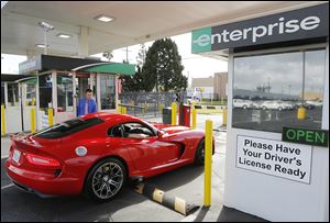 A renter checks out a 2013 Dodge Viper at the Enterprise Exotic Car Collection showroom near Los Angeles. Enterprise moved into the exotics market in 2006 after customers started asking for rarer models.