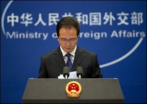Foreign ministry spokesman Hong Lei looks at the papers before he speaks during a daily briefing at the Ministry of Foreign Affairs office in Beijing, China, today.