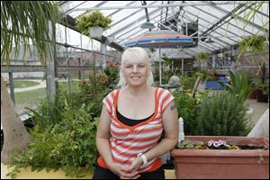 Kimberley Somers voluntarily cares for the greenhouse garden at Advanced Healthcare Center in South Toledo.