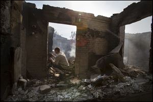 A journalist films a destroyed house following a mortar attack in Semyonovka village, outside Slovyansk, Ukraine, today. The village on the outskirts of Slovyansk, a city which has been the epicenter of clashes for weeks, has seen continuous shelling by the Ukrainian government forces, who have retaliated to the rebel fire.