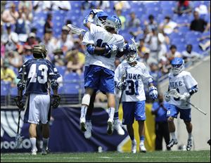 Duke's Myles Jones, center rear, and Deemer Class, center foreground, celebrate a goal against Notre Dame in the first half.