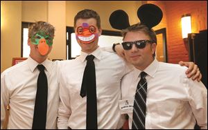 From left, attorneys Nic Linares, Ben Timmerman, and Andy McCarthy have fun at the Gridiron pre-show reception.