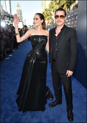 Angelina Jolie, left, and Brad Pitt arrive at the world premiere of 