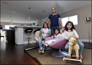 Imran and Aniqa Jaswal and children Arissa, right, and Jayda, pose in their house about 10 minutes from the beach in La Jolla, Calif., a state in which jumbo loans are higher than the national average.