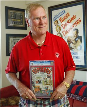 John C. Wise, poses in his San Diego home with a 1966 Super Boy comic. 