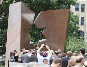Attendees file past the newly dedicated Holocaust and Liberators Memorial today at the Ohio Statehouse in Columbus.