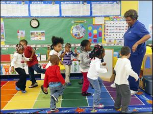 Linda Jefferson, the former Toledo Troopers football player, leads her Head Start class in a movement exercise during an afternoon class in March.