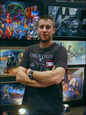 Local artist Brian Rood stands with some of his artwork.