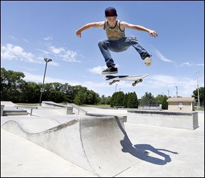 Clay Edwards, 15, flies high as he takes advantage of clear skies and warm weather at City Park in Bowling Green. 