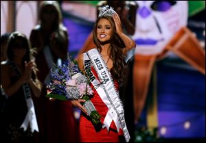 Miss Nevada USA Nia Sanchez adjusts her crown after  being crowned the new Miss USA during the Miss USA 2014 pageant in Baton Rouge, La., Sunday.