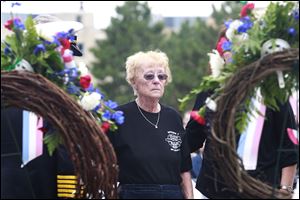 Sharon Machcinski, mother of fallen firefighter Stephen Machcinski, looks at the wreath placed for her son during the Toledo Fire Department's annual memorial service held at Chub DeWolfe Park in Toledo.