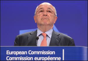 European Commissioner for competition Joaquin Almunia addresses the media at the European Commission headquarters in Brussels, today.