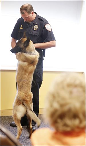 Lt. John Stewartof the Bowling Green State University police force introduces his bomb dog, Canine Jerry, during a news conference at BGSU’s Bowen-Thompson Student Union.