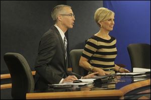 WTVG-TV, Channel 13, co-anchors Lee Conklin and Diane Larson address their viewers during a broadcast at their studio. 