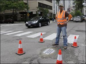 Mosaic artist Jim Bachor,poses next to his finished public art project on a street near downtown Chicago. 