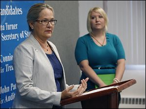 Polly Taylor-Gerken, left, a Toledo Board of Education member, and Tiffanny Adams, a second-grade teacher at Garfield Elementary School, call for accountability in for-profit charter schools, during a news con-ference Thurs-day at Lucas County Demo-cratic Party headquarters.