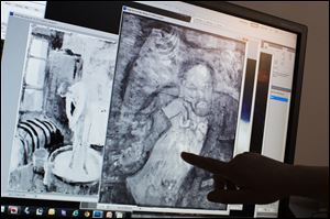 Patricia Favero, associate conservator at The Phillips Collection, points to an image of a man found underneath one of Picasso's first masterpieces, 