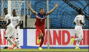 United States' John Brooks, center, celebrates after scoring the game-winning goal against Ghana.