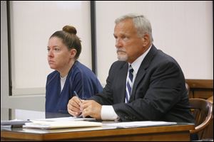 Lori Massingill, left, 29, of Ida, Mich., sits with her attorney  Scott Hicks, during a hearing before Judge Alan Mayberry during a hearing in Wood County Common Pleas Court today.