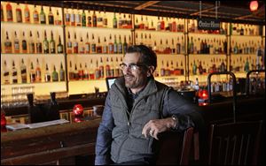 Actor Ty Burrell, who plays bumbling dad Phil Dunphy on ABC's “Modern Family,” sits at the bar at Bar X, the cocktail bar he co-owns, in Salt Lake City. 
