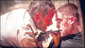 Guy Pearce and Robert Pattinson in a scene from ‘The Rover.’