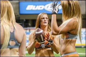 Crush quarterback Arika Hoffman, center, will lead Toledo in their season opener against the Baltimore Charm at the Huntington Center on Saturday.