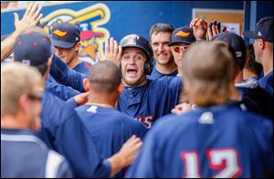 The Mud Hens’ Trevor Crowe celebrates his home run with his teammates to give Toledo a 2-0 lead in the first inning on Thursday.